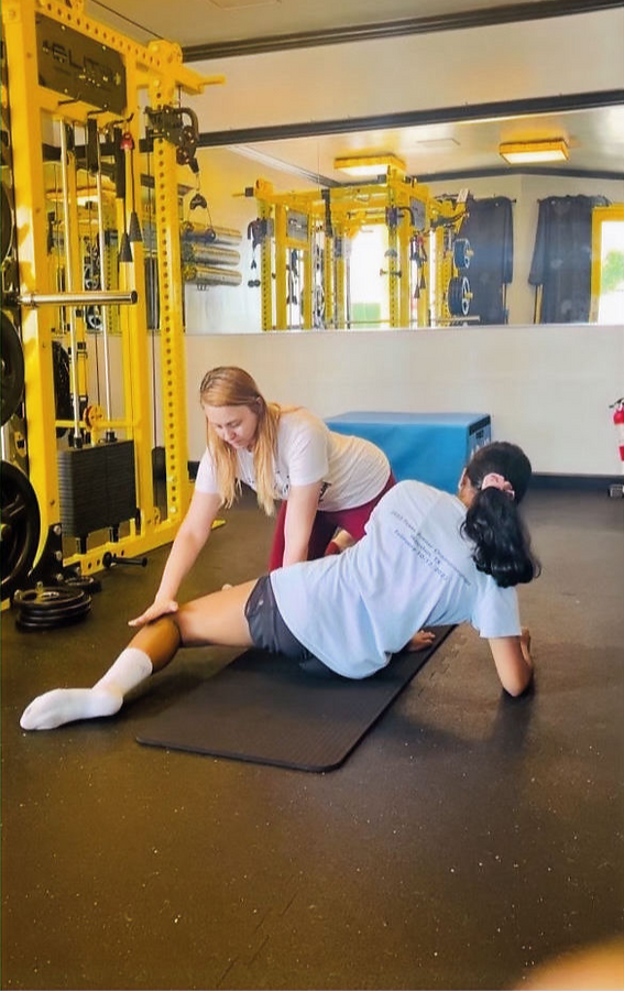 Coach Toma doing an assisted stretch