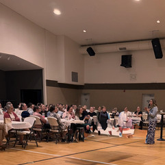 Cari Campos giving a message in a church gymnasium during the Truth to Liberty Conference