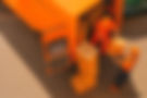 Two movers loading boxes into orange van