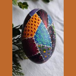 Pysanky egg with blue and gold patchwork design 