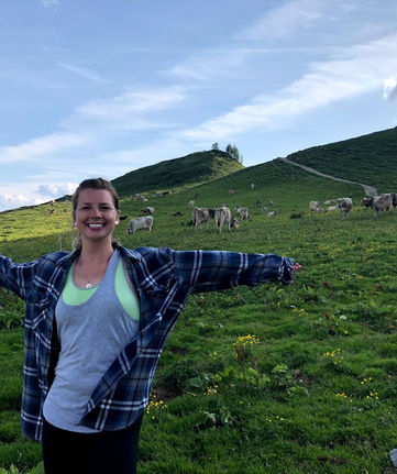 girl in swiss alps with cows