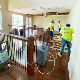 Crew completing interior floor demolition inside a residential property