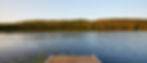 Background imagery of a lake showing a tree line and sky