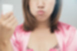 woman using Lavoris mouthwash