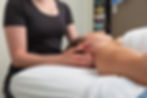 A therapist carefully administers a neck massage, providing relaxation and relief on a comfortable therapy table.