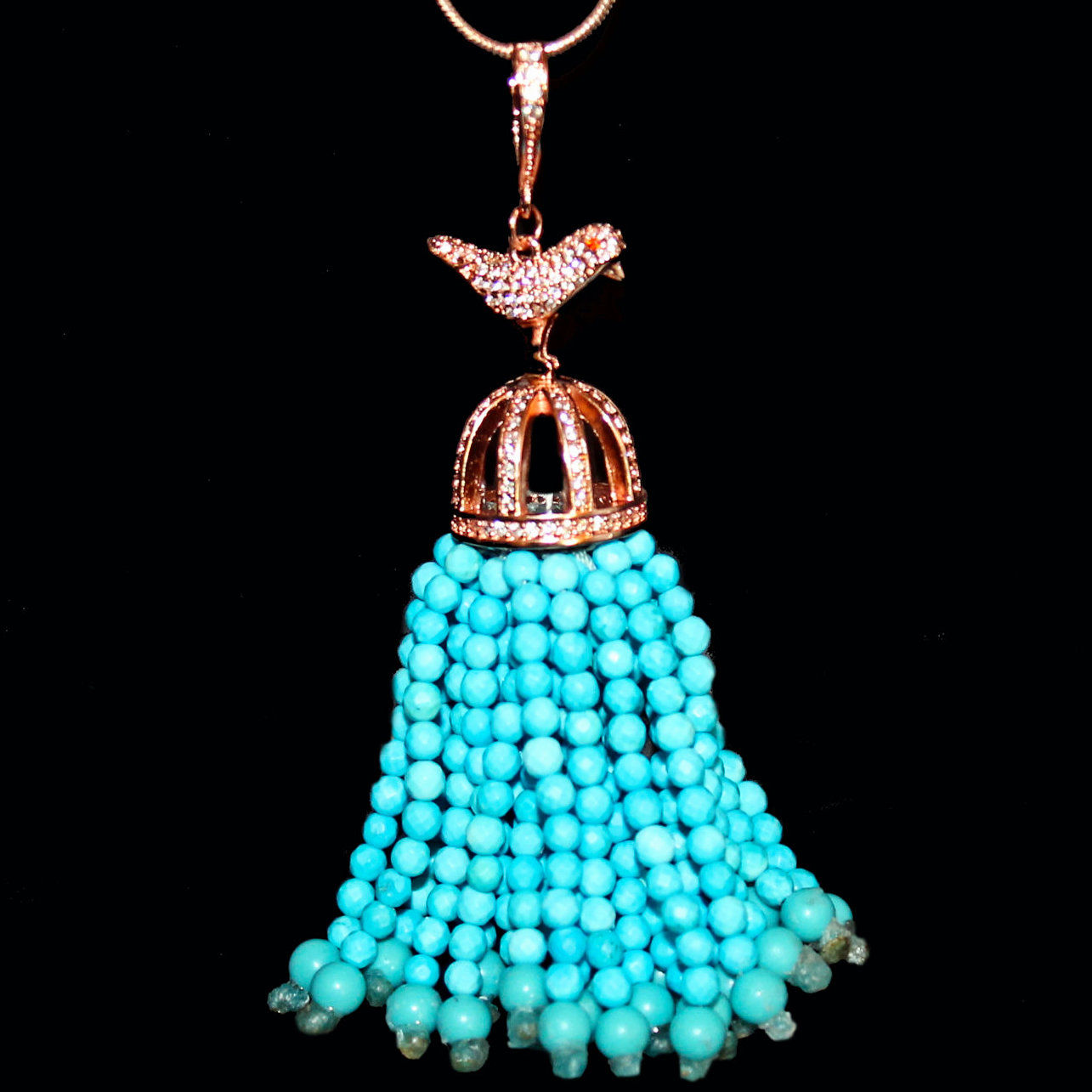 Rose gold-plated tassel pendant with turquoise beads in a birdcage setting