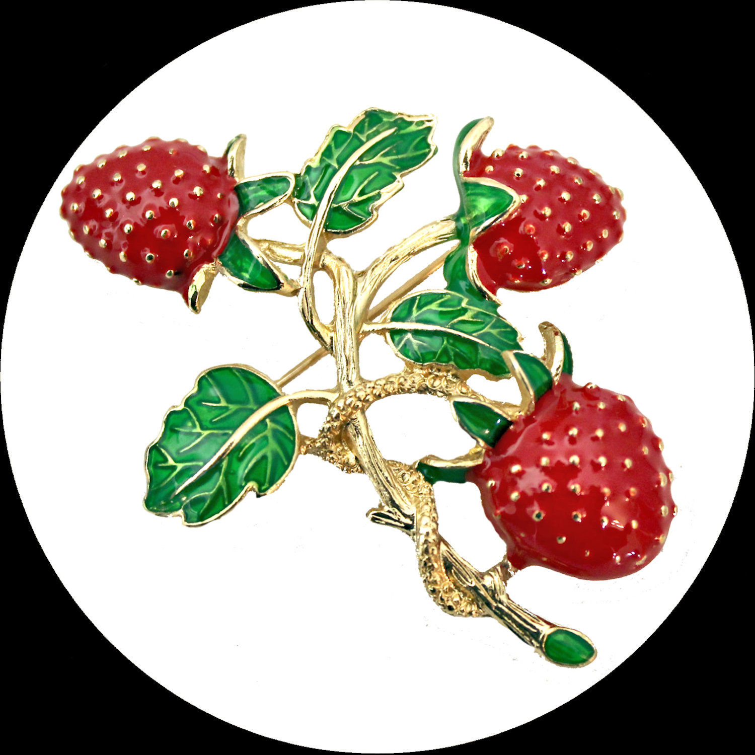 Red and green enamelled brooch with strawberries on a branch and leaves
