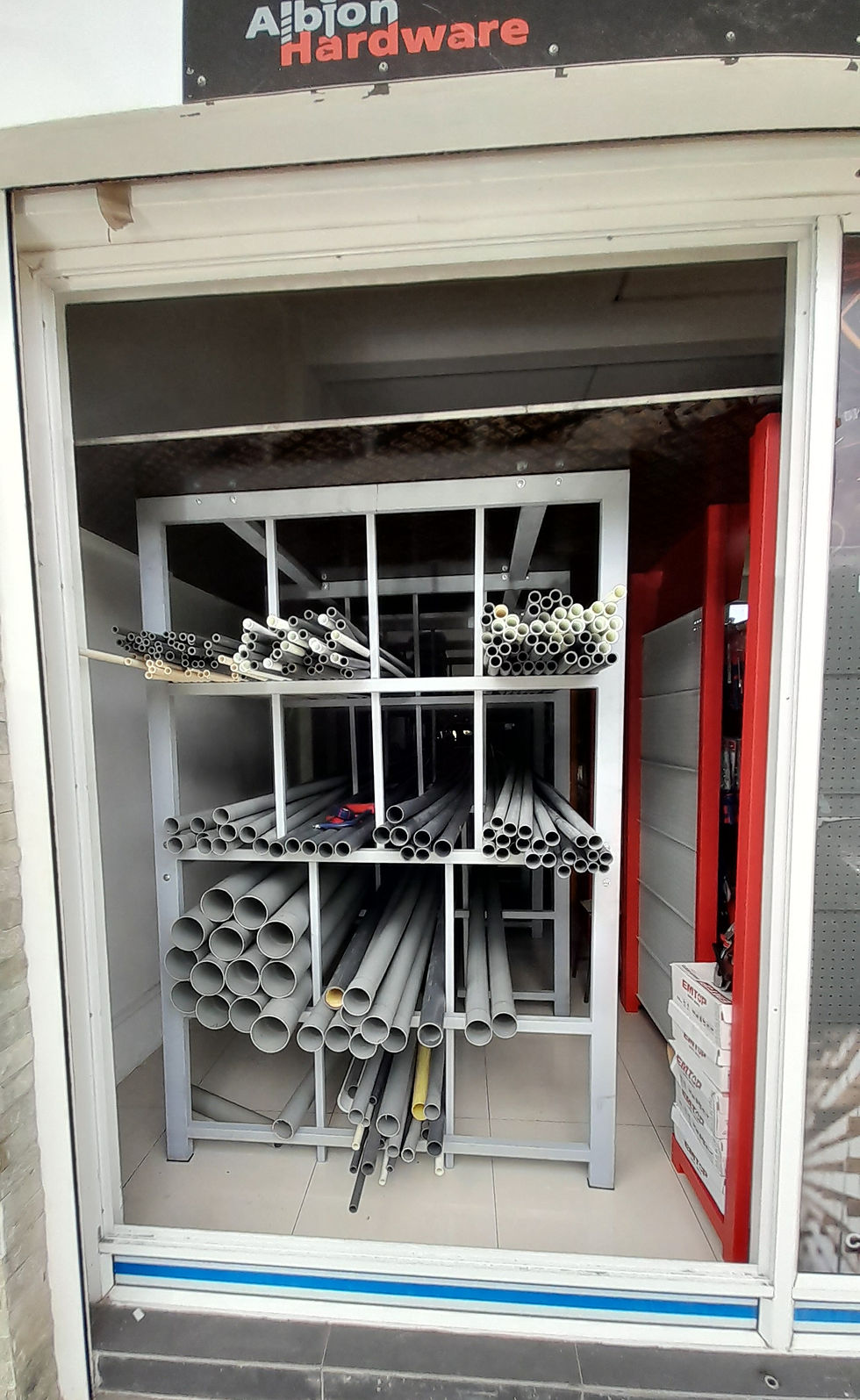 Operational Pipe Rack with various PVC Pipes displayed in Hardware Store