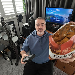Man with controller and snacks ready for a late start session at home