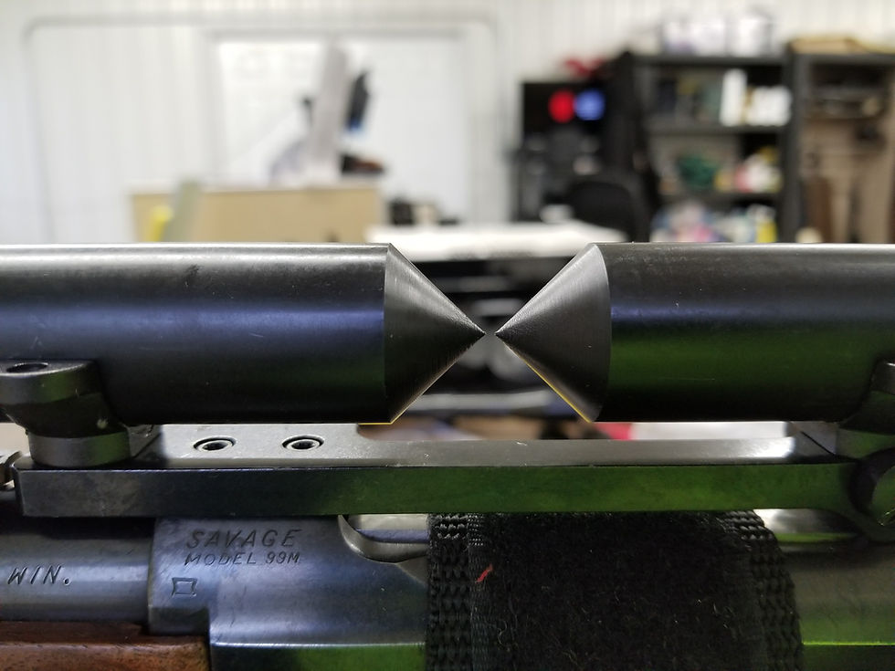 Close-up view of a gunsmith working on a rifle barrel