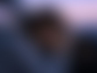 A woman leaning her head against a steering wheel in a car during twilight, illustrating the emotional exhaustion and the need for somatic release after a high-voltage astrological eclipse.