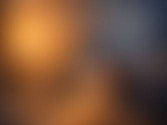 An illustration of a tired penguin wearing an orange scarf, leaning over a cluttered desk with a laptop, steaming coffee, and crumpled papers. Above the penguin, a low-battery icon is displayed alongside celestial symbols for the sun, moon, Saturn, and Neptune, set against a backdrop that transitions from a warm sunset to a dark, stormy sky.