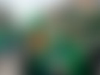 A joyful group of friends celebrating St. Patrick’s Day together, laughing in a festive street setting while wearing vibrant green hats and shamrock sweaters.