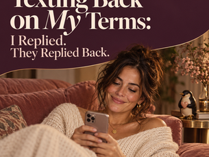 Texting back on my terms: a smiling woman in a cream knit sweater reads her phone on a rose velvet sofa beside a penguin figurine holding a heart