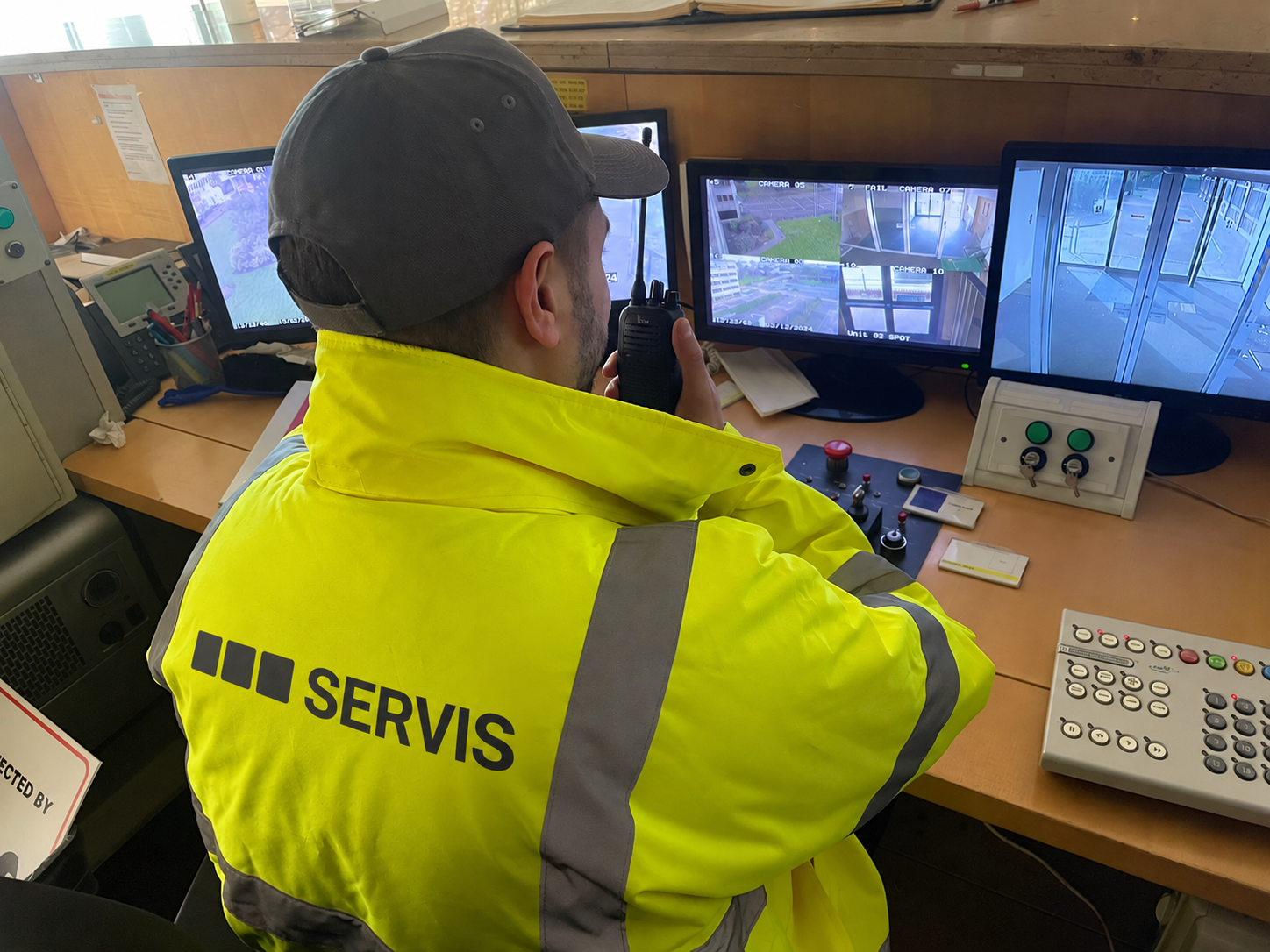 Servis control-room colleague monitoring security screens