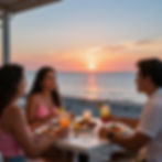 Three people dining on a beach at sunset
