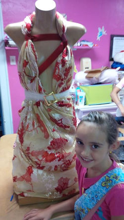 Facebook - Peyton 7 years old helped me drape a dress for tradeshow today and sh