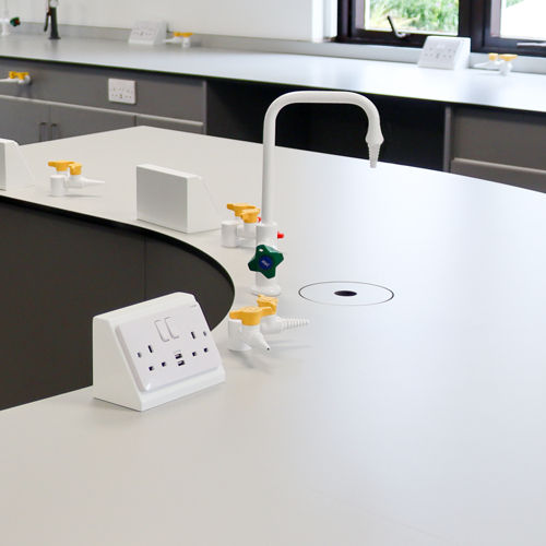 Curved bench with mounted gas taps and electrical housing