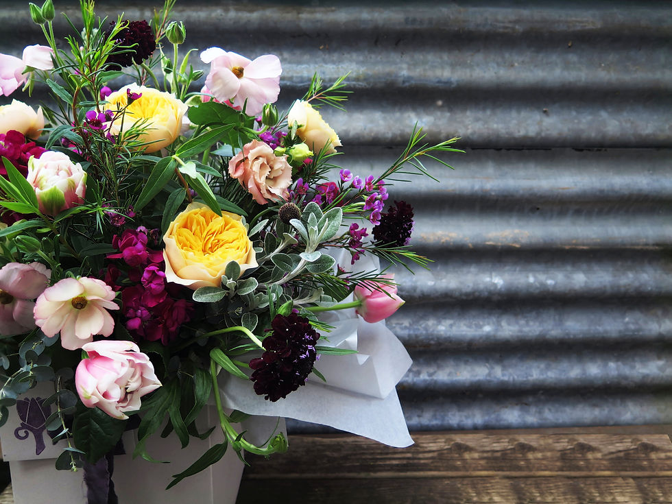 Pop of yellow roses in a mixed flower bouquet