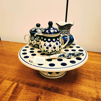 Cake Plate - Bold Polka Dots | Spreading Knife 7" - Country Garden | Vase with Wavy Edge 4" - Blue Cosmo - Unikat (U4) Pattern | Sugar Bowl - Peacock | Pitcher with Lid 8oz - Bleeding Heart - Ceramika Artystyczna Bolesławiec Polish Pottery - The Amish Home - Galleria at Pittsburgh Mills Amish Furniture