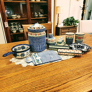 Baker with Handle 10" - Blue Poppy | Cutting Board 12" - Limeberry | Fermenting Crock with Water Seal Airlock - Rose Wreath | Vase 6" - Red Pansy | Corn/Cracker Tray - Rosy Cheeks | Corn/Cracker Tray - Evergreen Wreath | Egg Plate 8" - Bleeding Heart | Salt & Pepper - Blue Bell Wreath | Mug 16oz - Babcia's Garden | Mug 16oz - Blooming Daisies - Unikat (U3) Pattern - Ceramika Artystyczna Bolesławiec Polish Pottery - The Amish Home - Galleria at Pittsburgh Mills Amish Furniture