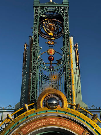 Ornate themed entrance structure with celestial design elements against a clear sky at Universal's Epic Universe in Florida.