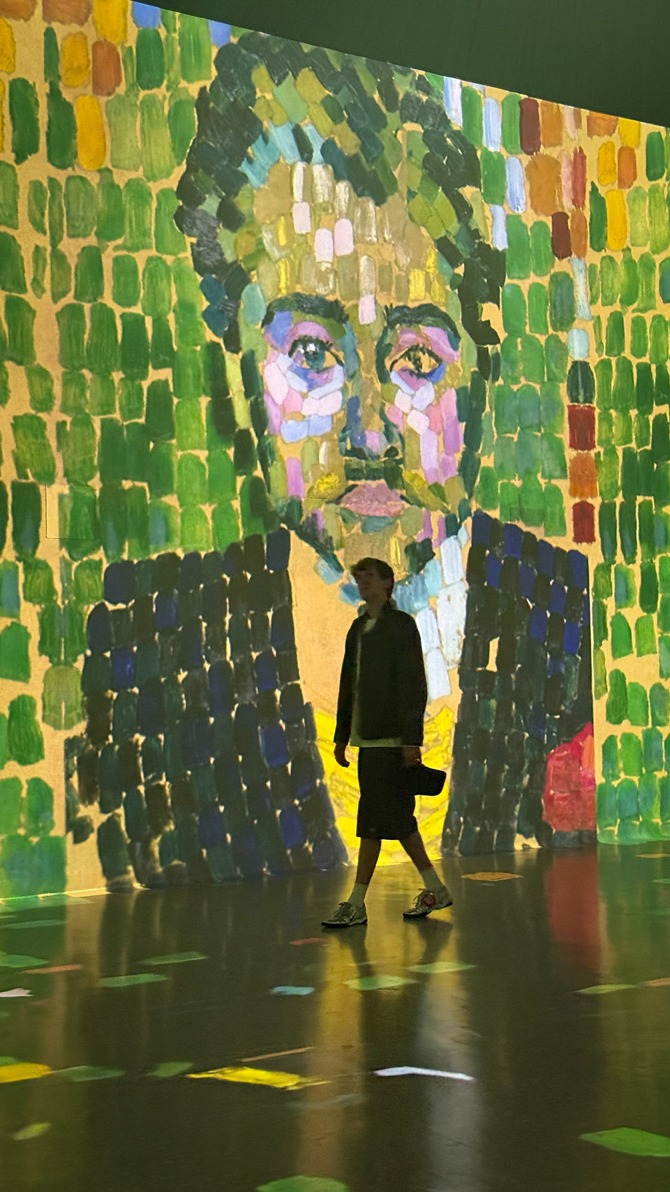 Animated modern portrait projection composed of colorful brushstrokes inside Frameless London immersive art experience