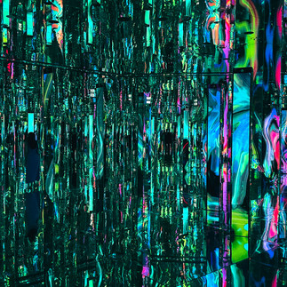 Mirrored room featuring vertical LED elements and colorful projections creating visual depth at AYA Universe Dubai.