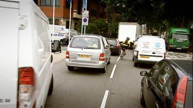 Top Gear Series 10 Episode 5 - Richard Hammond on a bicycle riding through heavy traffic in London.