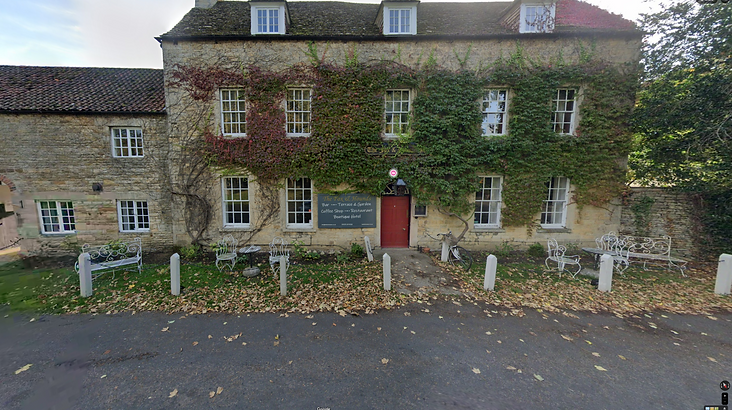 Top Gear Series 17 Episode 3 - Jeremy is standing near the Nissan Pixo in front of an old English styled Hotel and Inn explaining that the Pixo is very cheap but wondering if you could buy something older for the same price that is much more interesting.