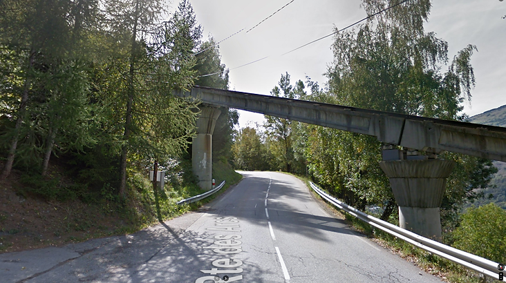 Top Gear Series 11 Episode 2 - The Audi RS6 V10 twin turbo driving under a railway bridge on a mountain road near Tignes, France in the Alps.