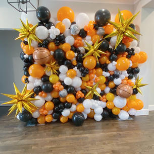 Orange, white and Black balloon wall 
Gold starburst on balloon wall