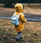 Fully dressed toddler heading toward water