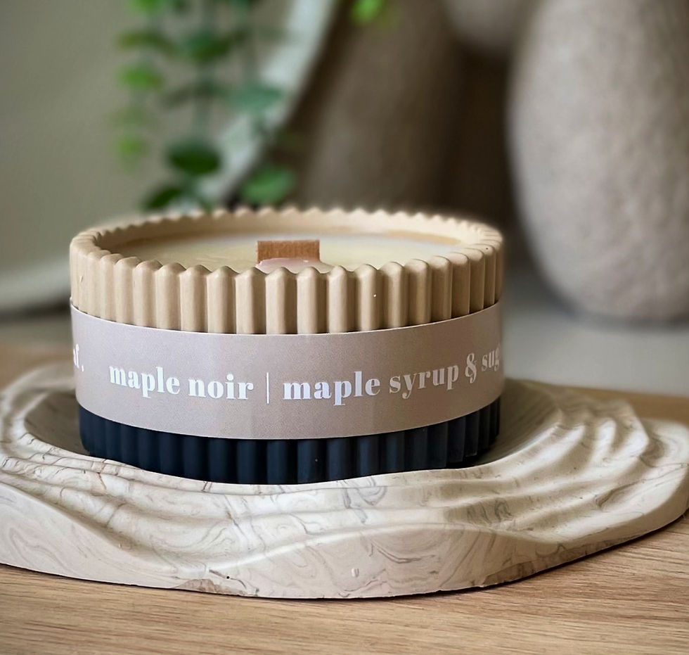 A candle with a wooden wick sat on a table