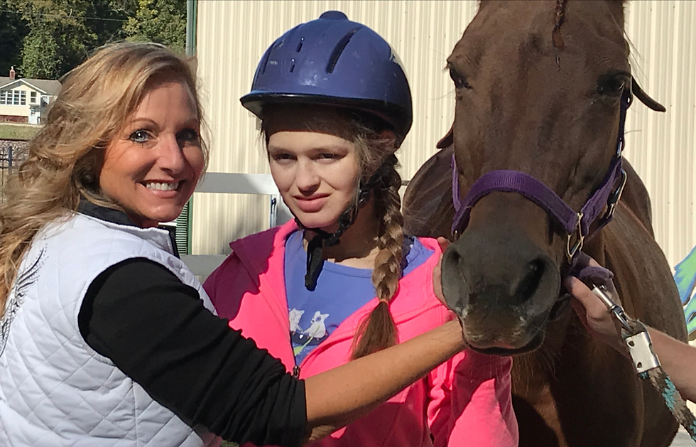 Ride On St. Louis volunteer Kami, participant Katelyn and horse Pharma pose after a session