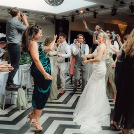 Guests dancing during singing waiters performance at Old Thorns wedding