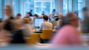 busy, chaotic open-plan office with people multitasking distractedly