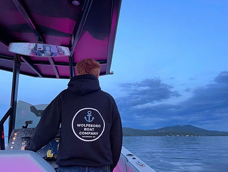 nate driving boat with wbc sweatshirt.jpeg