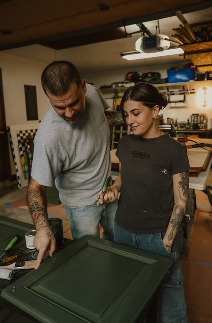 Nathan and Marina owners of O'Hair Restorations smiling and working together