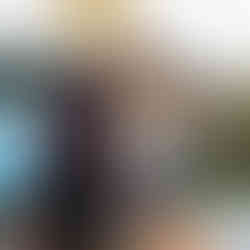 A bride and groom cut their pizza together.