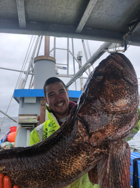 Fisherman holding up large fish