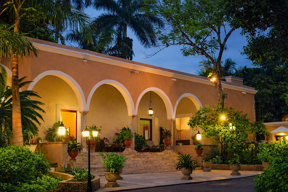 Historic Hacienda Chichen building surrounded by tropical gardens