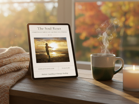 A cosy autumn scene with an iPad on a wooden table by the window, displaying “The Soul Reset” free guide. A steaming mug and candle sit beside it, with a blanket folded nearby and autumn leaves outside. Perfect self-care and holistic wellness vibe.