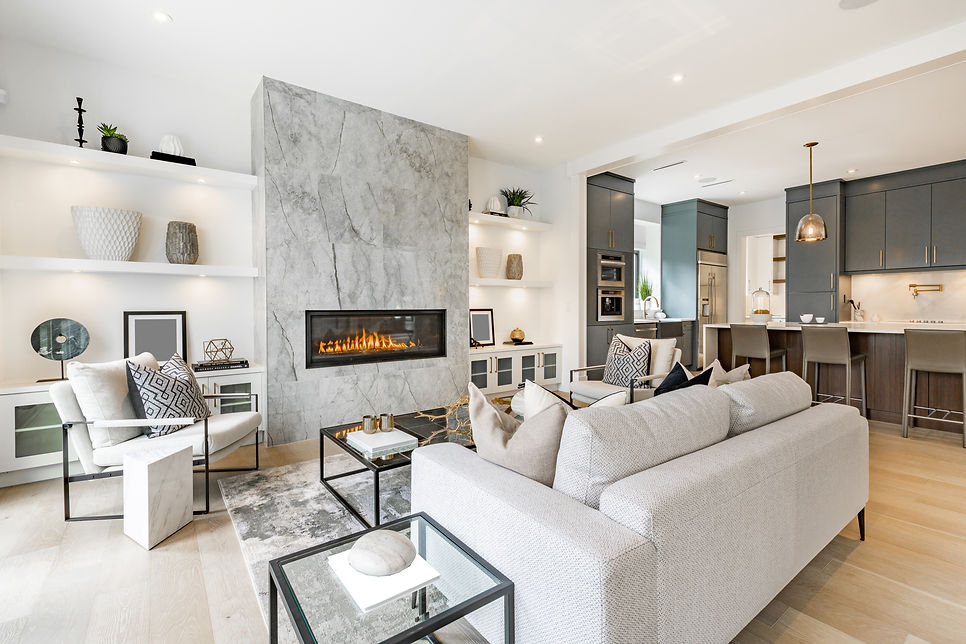 Downsizing: contemporary living room with open concept view through to dining room kitchen and a marbl