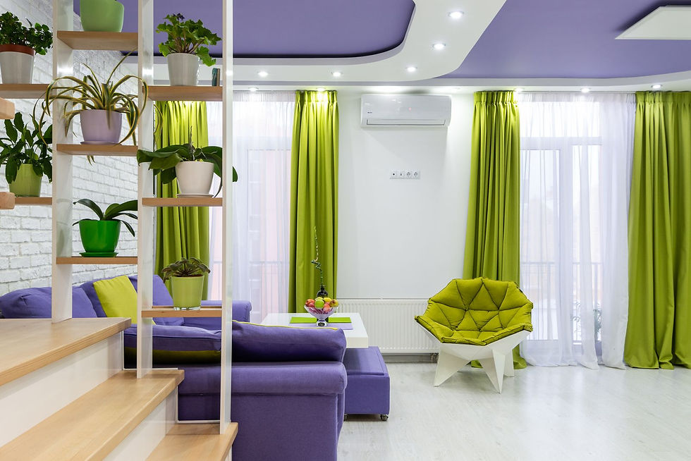 A contemporary living room with green and purple furnishings and houseplants.
