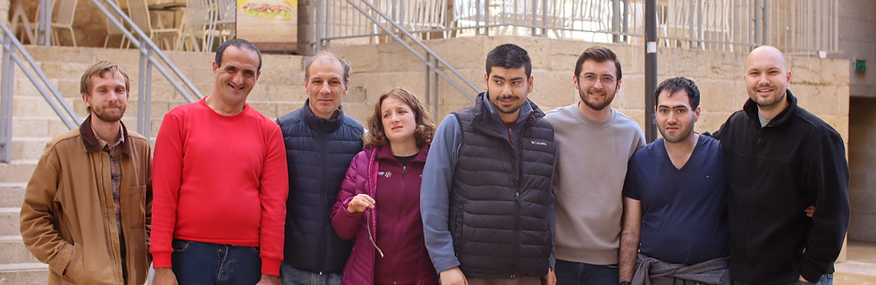 Team of eight people standing outdoors