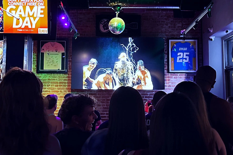 Crowd gathers at GYM Bar in West Hollywood for the premiere of Lê Khoa’s “SPIT” music video, featuring vibrant visuals and dynamic performances.