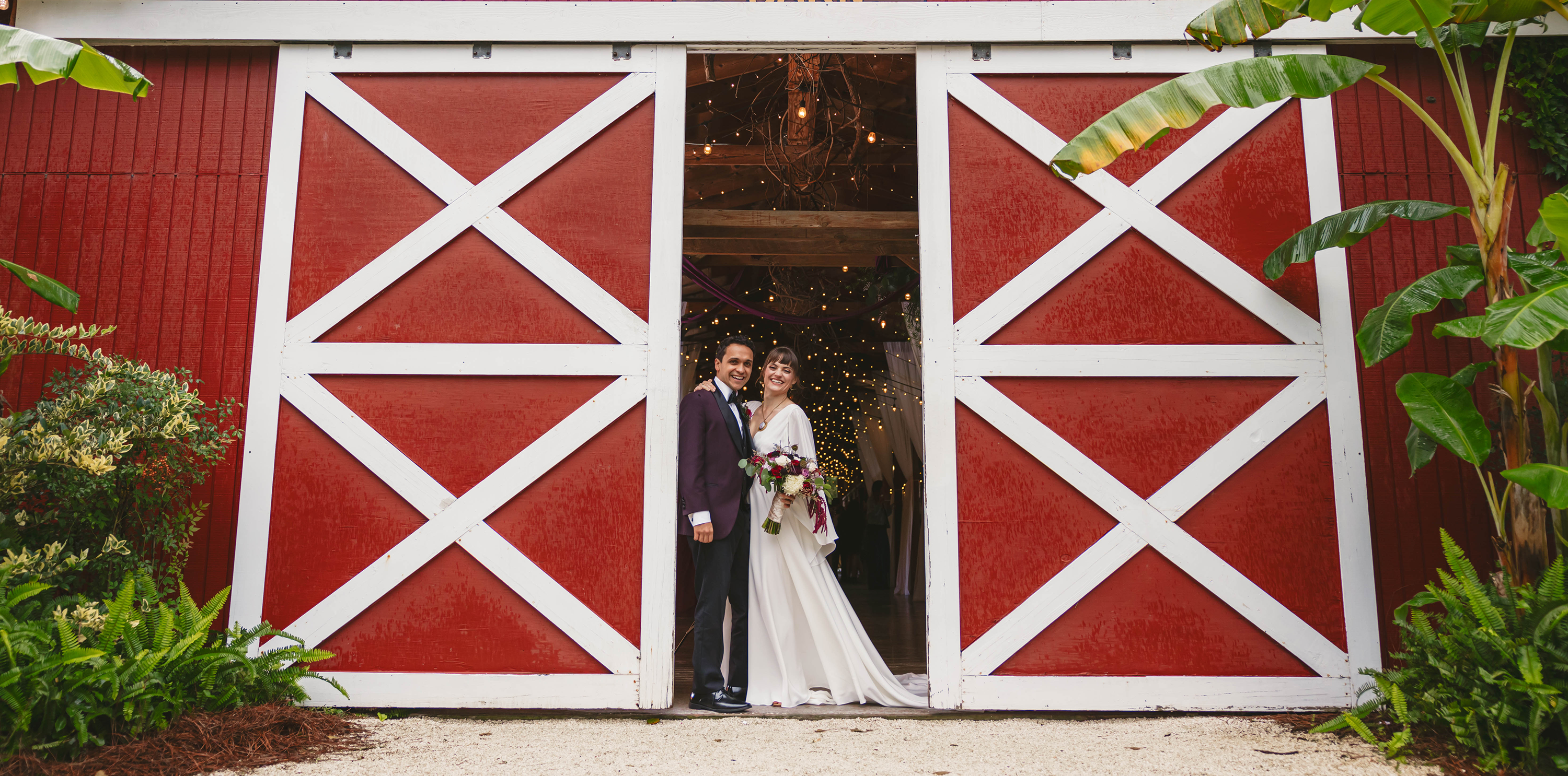 Red Gate Farm's Barn's traditional red doors incorporated into a stunning wedding portrait