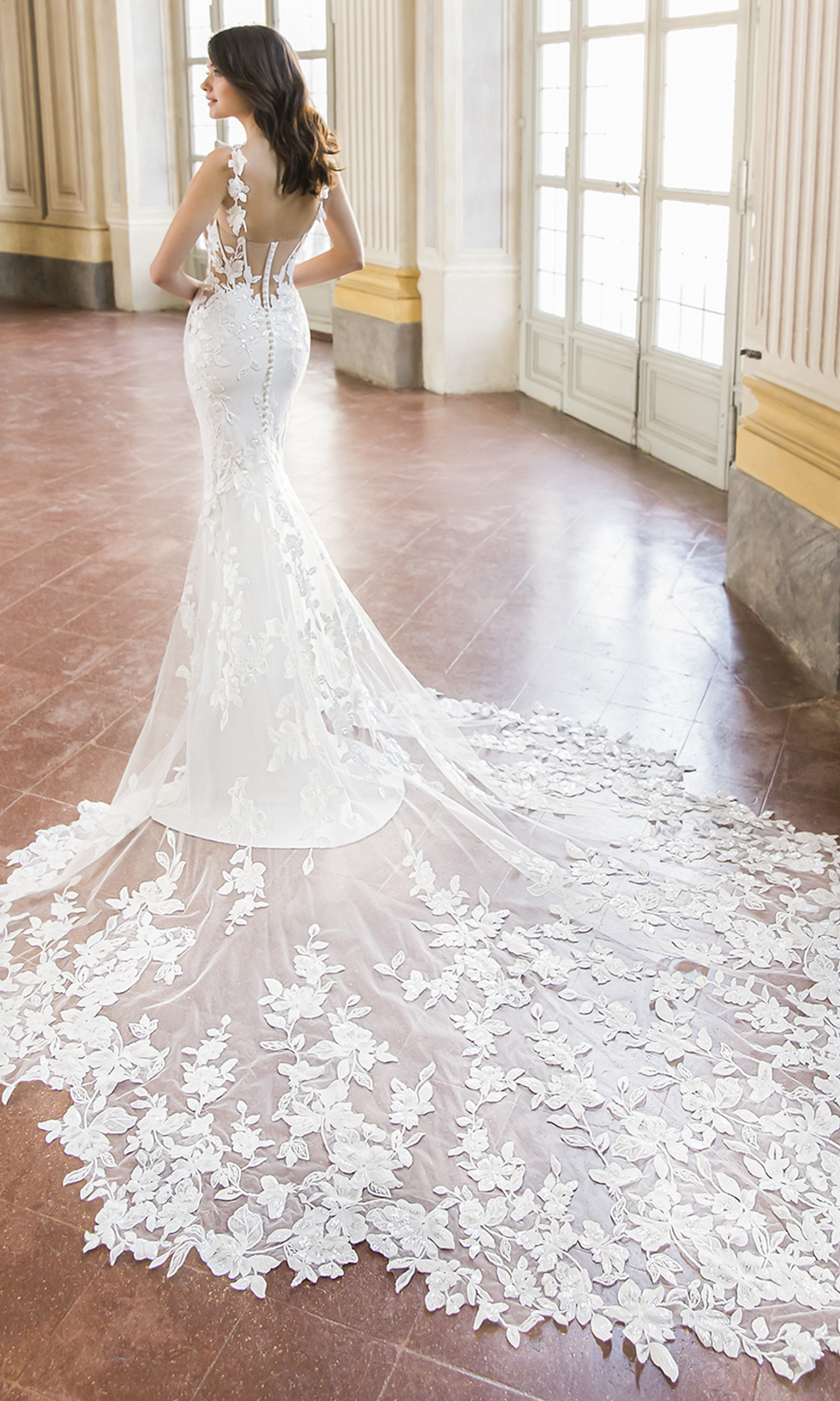 woman wearing a wedding dress with long lace trail
