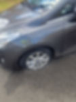 Damaged tyre on grey car